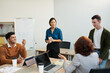 © DragonImages - Group of business people talking at meeting in office, sharing ideas and discussing news
