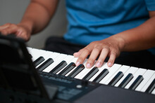 Asian Man Playing Kosaf Piano In Hand