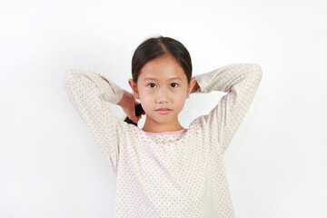 Wall Mural - Cute Asian young girl child tie her hair and looking at camera on white background. Child Care concept.