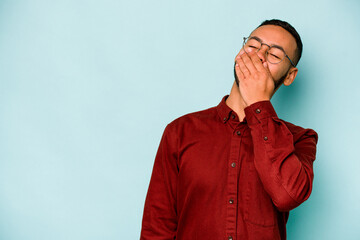 Wall Mural - Young hispanic man isolated on blue background laughing happy, carefree, natural emotion.