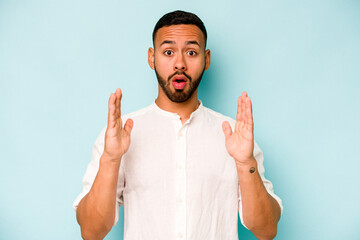 Wall Mural - Young hispanic man isolated on blue background having an idea, inspiration concept.