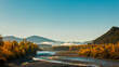 River and trees sunset in autum. With mountains in background.  Ainsa in Pyrenees. Pirineos
