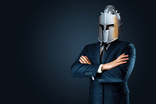 Creative Image, A Man In A Modern Suit Of A Businessman, A Knight's Helmet On His Head, Armor. The Concept Of A Modern Hero, Overcoming Difficulties, A Crisis, A Good Manager. Magazine Style