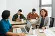 © DragonImages - Female colleagues having emotional conversation in open space office