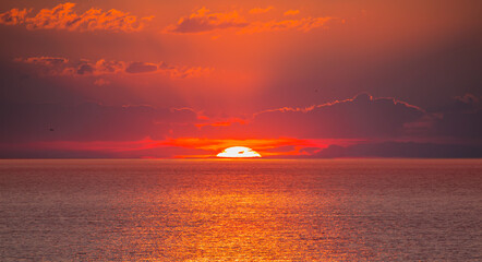 Wall Mural - Amazing red sunset with yellow sun over the sea - Alanya, Turkey