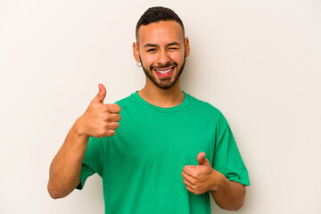 Wall Mural - Young hispanic man isolated on white background raising both thumbs up, smiling and confident.