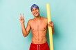 © Asier - Young caucasian swimmer man holding foam stick isolated on blue background joyful and carefree showing a peace symbol with fingers.