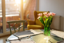 Beautiful Fresh Pink Tulips Bouquet In Green Glass Vase On Table In Warm Sunset Sun Lights Against Balcony Window In Cozy Home Interior. Blooming Flowers Decoration In Living Room Provence Style