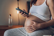 © ikostudio - Pregnant woman calling medical assistance