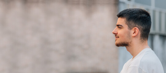 Poster - young man looking in profile with copy-space