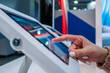 © zyabich - Woman hand using touchscreen display of interactive floor standing white tablet kiosk at exhibition or museum - close up side view. Futuristic, education, entertainment, learning, technology concept