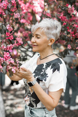 Wall Mural - adult caucasian female aged in a blooming garden