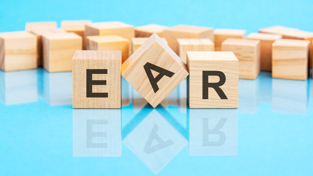 ear - text on wooden cubes on the bright lying blue table