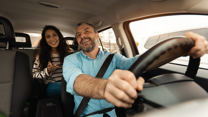 Happy couple enjoying drive on new car