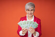 joyful adult businesswoman with euro in her hands