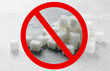 Sugar cubes and prohibition sign on grey background