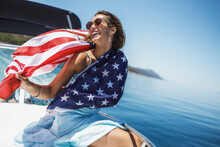 Woman With US National Flag Spending Day On Private Yacht