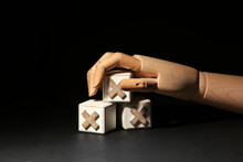 Wooden Hand With Cubes On Black Background