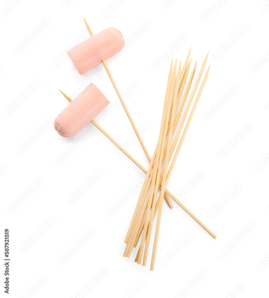 Wooden skewers with sausage on white background