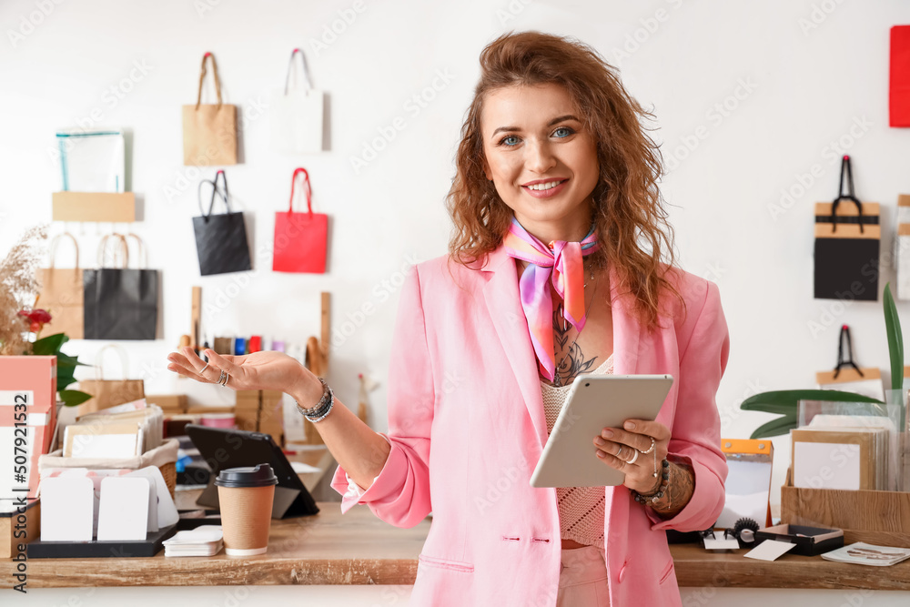 Female business owner with tablet in her shop