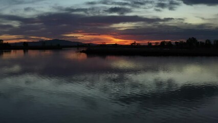 Sticker - Drone Aerial Flying Quickly Left Over Lake Surface at Sunset