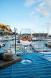 Rose wine in glass served with goat cheeses on outdoor terrace with view on old fisherman's harbour with colourful boats in Cassis, Provence, France