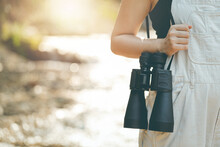 Girl Holding Binoculars By The Water