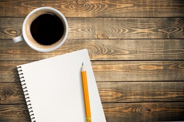 Sticker - A notebook with pencil  and coffee cup on desk texture.