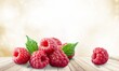 © BillionPhotos.com - Basket of ripe raspberries with a garden natural background.