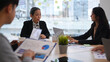 © Prathankarnpap - Experienced senior female team leader talking, giving instructions to diverse staff at corporate office