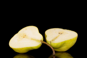 Two halves of a juicy yellow pear, close-up, isolated on a black background.