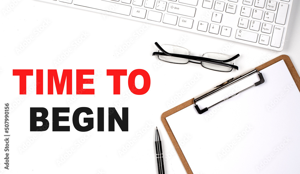 TIME TO BEGIN text written on the white background with keyboard, paper ...