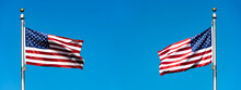 Two The USA Flags On Flagpole Waving Against Blue Sky, Panoramic Picture, Space For Text