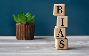 BIAS - acronym on wooden cubes on the background of a cactus