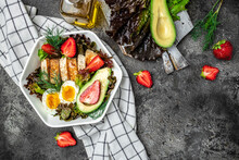 Healthy Nutritious Paleo Keto Breakfast Diet Two Eggs, Avocado, Grilled Chicken Fillet, Nuts, Strawberries And Fresh Salad. Keto Breakfast Or Lunch. Place For Text, Top View