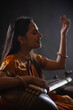 © IndiaPix - Close-up view of a female musician performing with Tanpura at concert