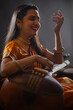 © IndiaPix - Close-up view of a female musician performing with Tanpura at concert