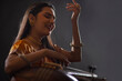 © IndiaPix - Close-up view of a female musician performing with Tanpura at concert