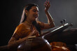 © IndiaPix - Portrait of a female musician performing with Tanpura at concert