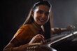 © IndiaPix - Close-up view of a female musician performing with Tanpura at concert