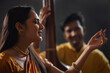 © IndiaPix - Close-up view of a young female musician performing on stage and a man accompanying her on tanpura