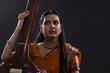 © IndiaPix - Close-up view of a female musician performing with Tanpura at concert