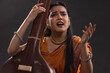 © IndiaPix - Close-up view of a female musician performing with Tanpura at concert
