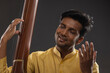 © IndiaPix - Close-up view of a male musician performing with Tanpura at concert