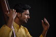 © IndiaPix - Close-up view of a male musician performing with Tanpura at concert