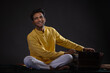 © IndiaPix - Portrait of cheerful young man performing with Harmonium at concert