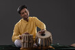 © IndiaPix - Portrait of young man performing with Tabla on stage