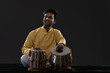© IndiaPix - Portrait of young man performing with Tabla on stage