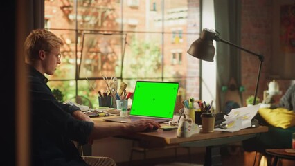Aufkleber - Male Specialist Working on Desktop Computer with Green Screen Mock Up Display at Loft Modern Place. Teenage Freelancer Designing Eco Friendly Shoes Using his Laptop. Static Shot