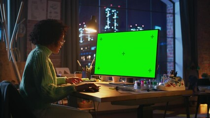 Poster - Diverse Professional Freelancer Working on Green Mockup Screen Personal Computer From Home. Woman Considering at Screen, Browsing Through the Internet, Using Computer